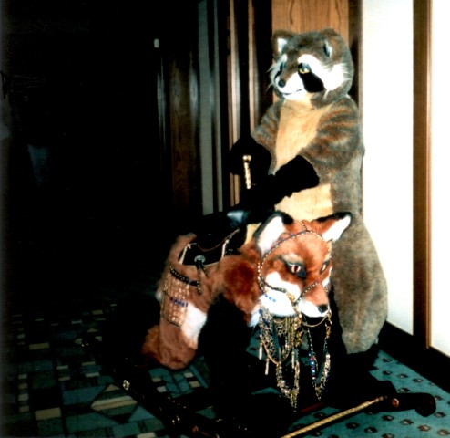 Raccoon offers rides on rocking fox.